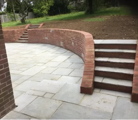 Garden patio with retaining wall and steps
